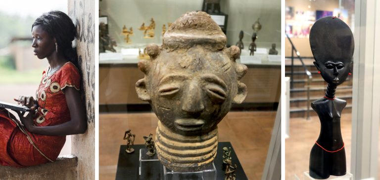 West African artifacts on display in the Akwaaba: Journey to West Africa exhibit in the World Culture Gallery. A west African woman in traditional dress interacting with a modern tablet. Also included a west African clay bust and black stylized depiction of a female figure with red jewelry accents.