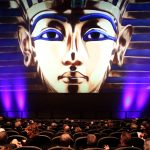 The GIANT Screen Theater at the Putnam Museum, featuring a full audience with an image of King Tut on the movie screen.
