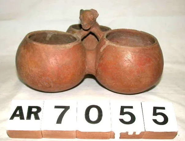 Red stoneware bowl featuring three bowls connected with an animal head decoration, from the Putnam collection.